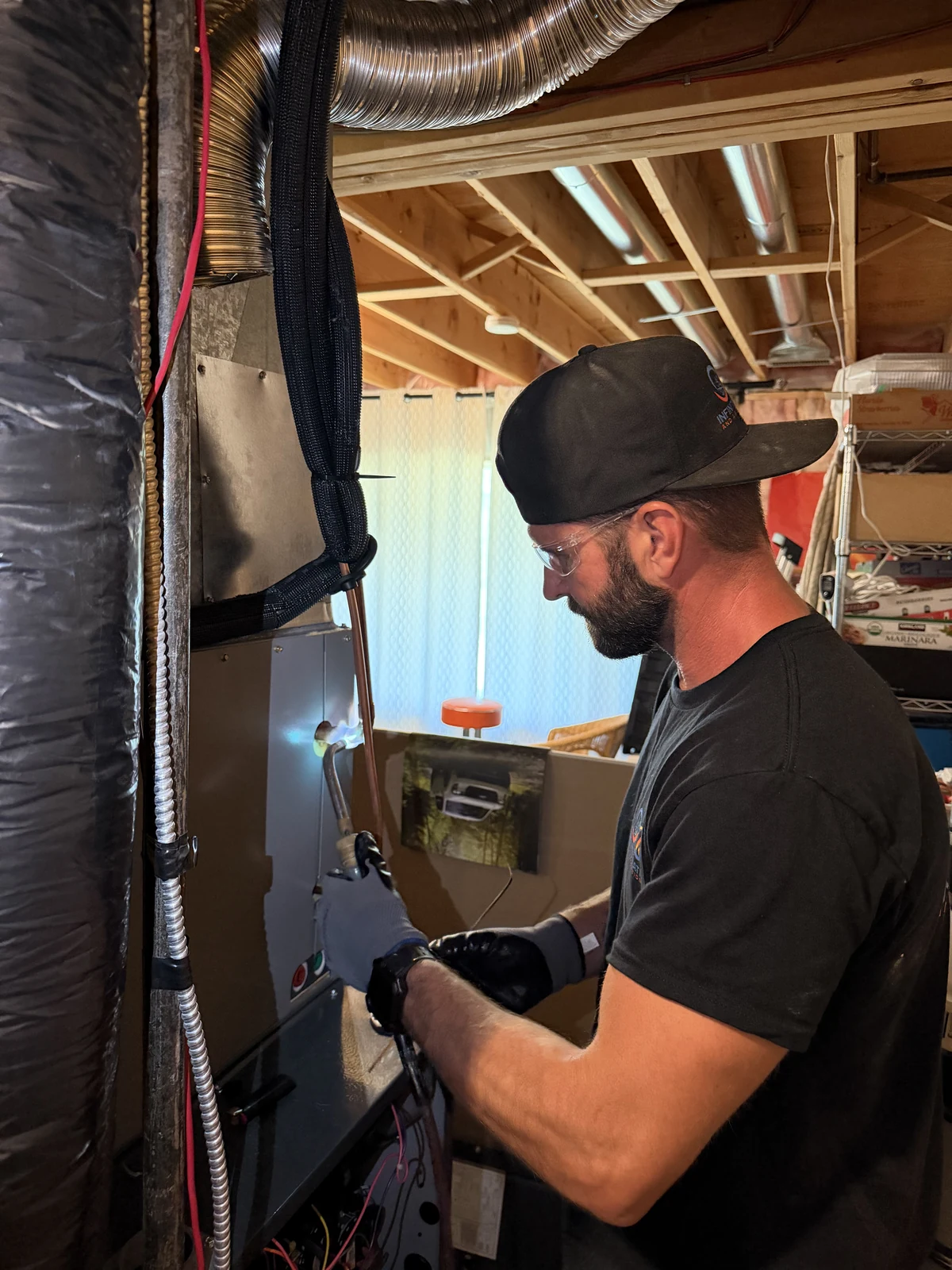 Infinite Heating technician working on residential HVAC equipment