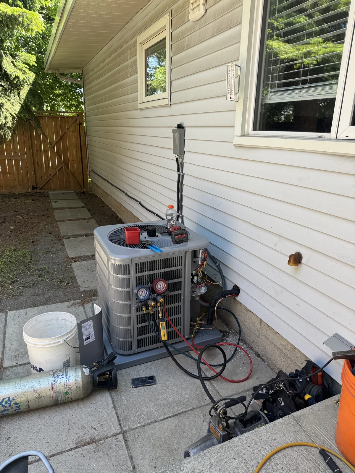 Air conditioner diagnostic service with tools and gauges connected