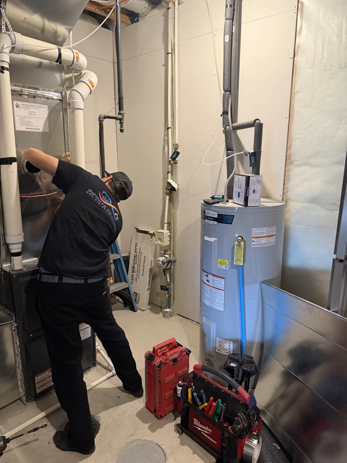 Infinite Heating technician servicing residential hot water equipment
