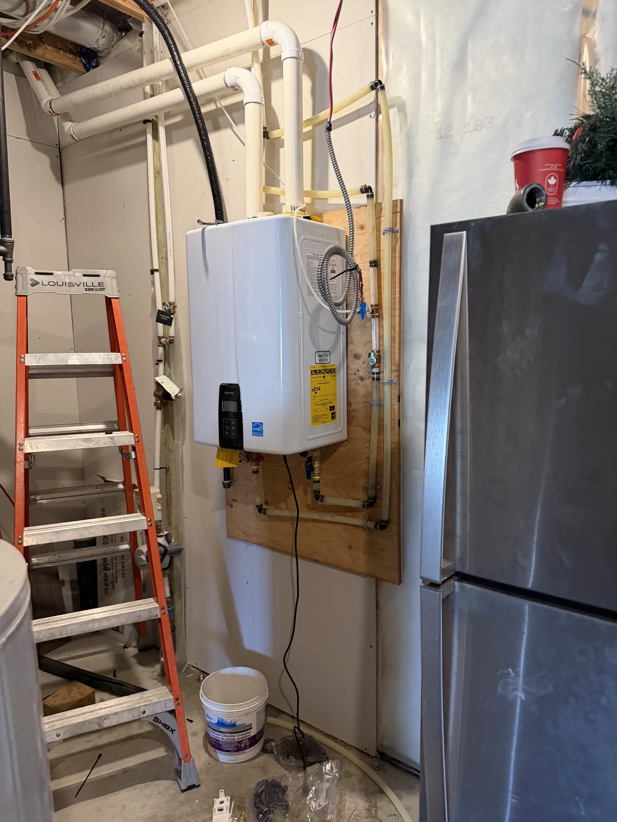 Tankless hot water heater installed in a residential utility area