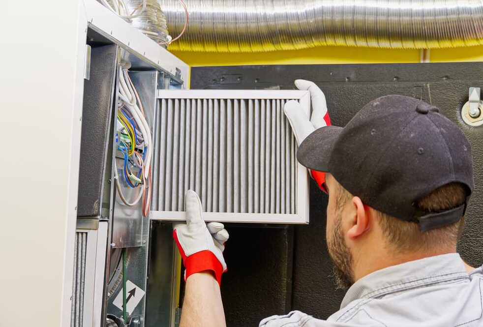 Man Cleaning HVAC System e1751698577965